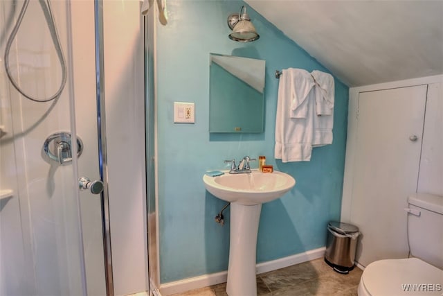 full bathroom with toilet, a stall shower, vaulted ceiling, and baseboards