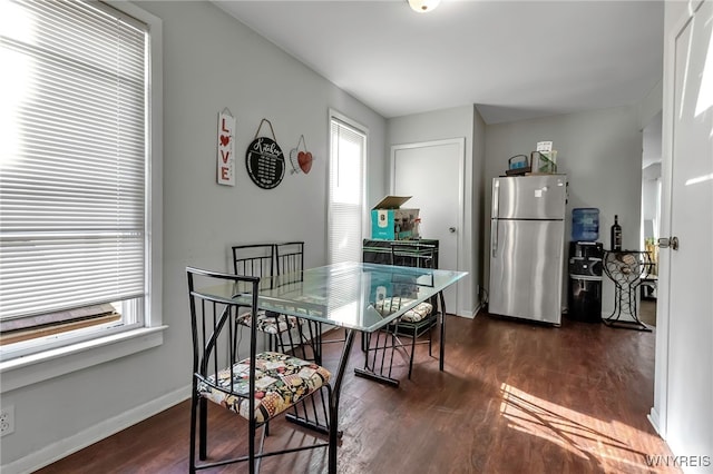 dining space with dark wood-style floors and baseboards