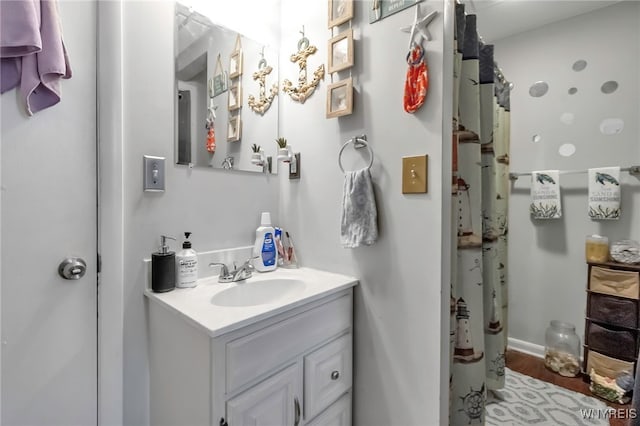 bathroom featuring a shower with curtain, wood finished floors, and vanity