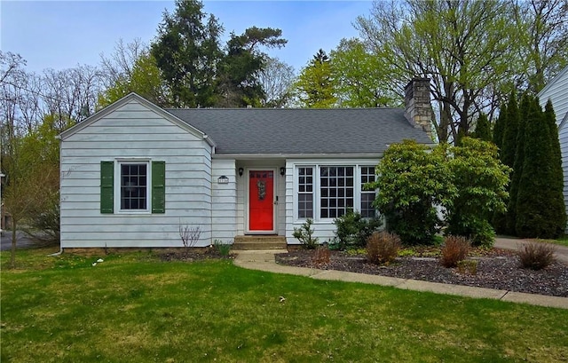 view of front facade with a chimney, entry steps, and a front lawn