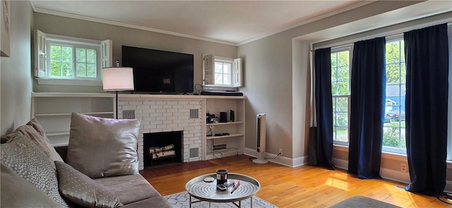 living area with wood finished floors, crown molding, and plenty of natural light