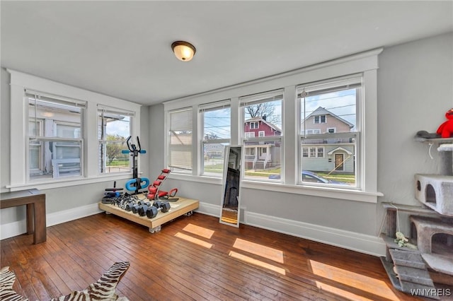 recreation room with baseboards and hardwood / wood-style flooring
