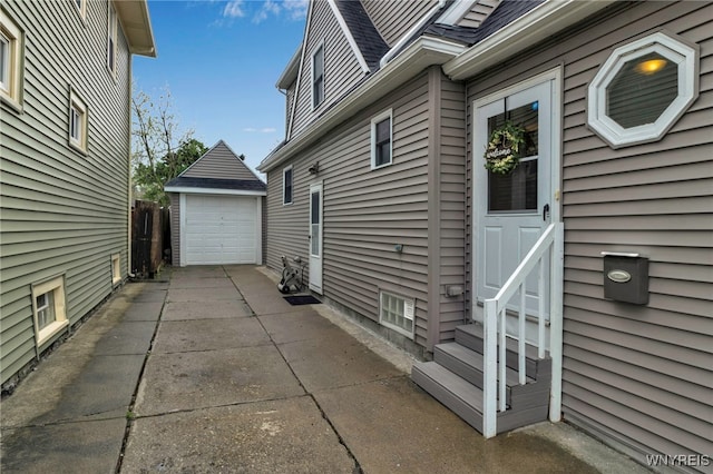 view of home's exterior featuring a garage, an outdoor structure, driveway, roof with shingles, and entry steps
