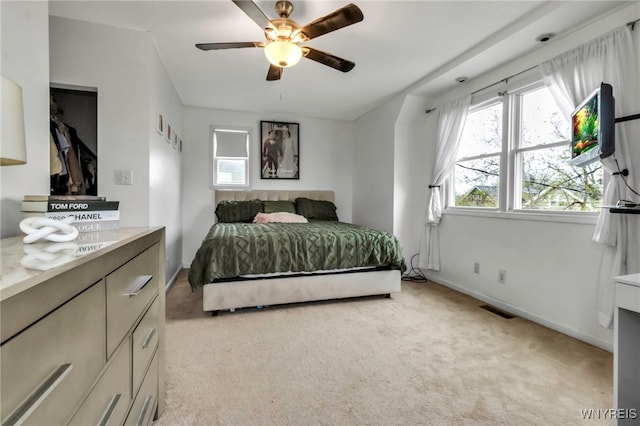 bedroom featuring visible vents, ceiling fan, light colored carpet, and baseboards