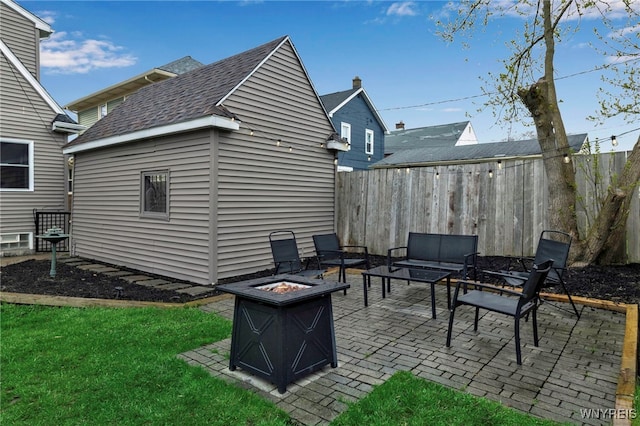exterior space with fence, an outdoor structure, and an outdoor fire pit