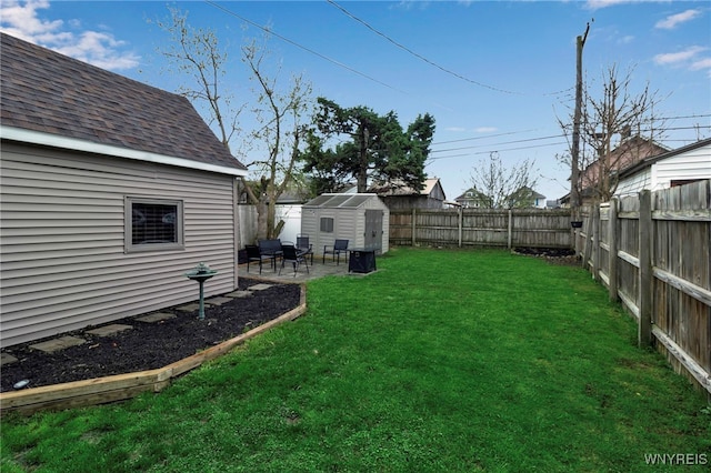 view of yard with an outdoor structure, a patio area, a storage shed, and a fenced backyard