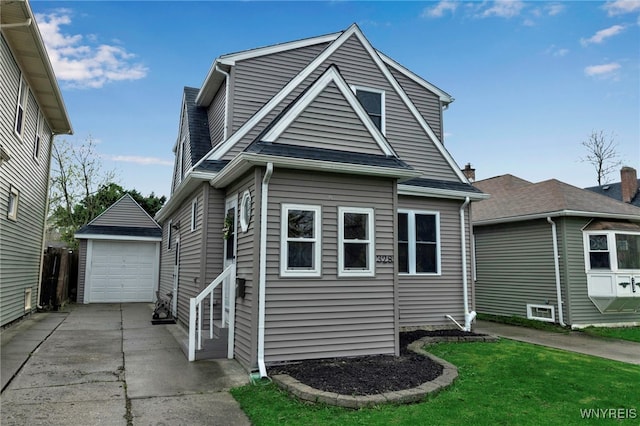 bungalow-style home featuring a garage, a front lawn, and an outbuilding