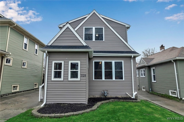 rear view of property with a yard