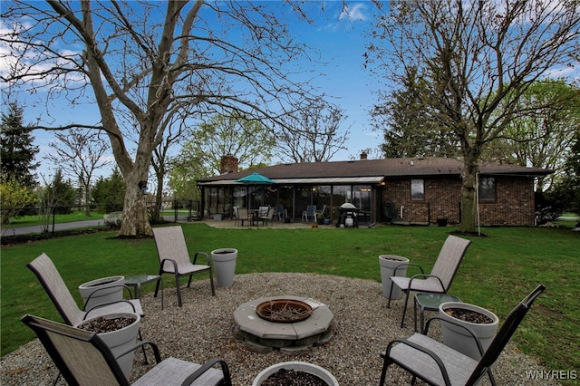 exterior space featuring fence, a fire pit, and a patio