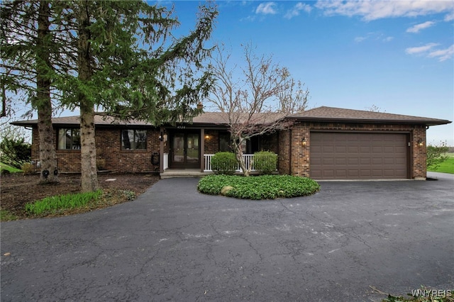 view of front of house with brick siding, driveway, and an attached garage