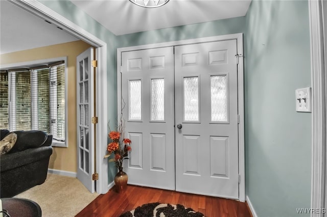 entryway with wood finished floors and baseboards