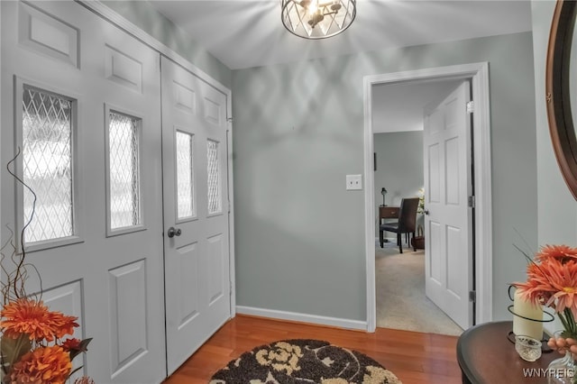 foyer featuring baseboards and light wood-type flooring