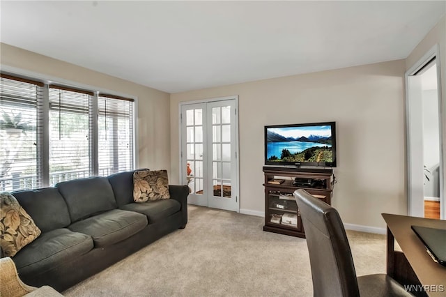 living room with light carpet, french doors, and baseboards