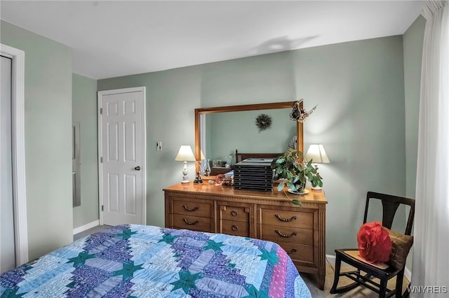 carpeted bedroom featuring baseboards