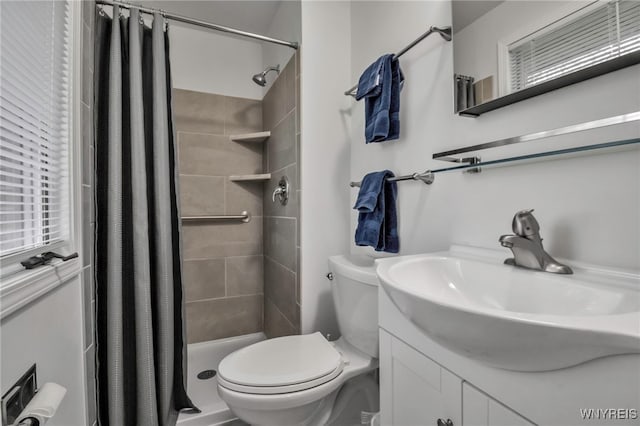 bathroom featuring a stall shower, toilet, and vanity