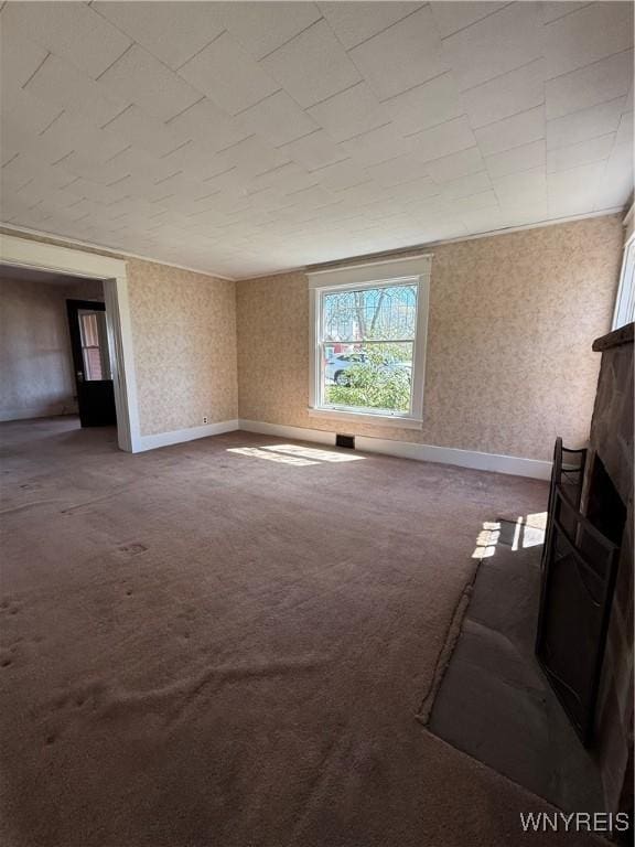 unfurnished living room with carpet floors and a fireplace