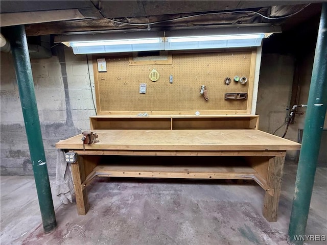 unfinished basement featuring a workshop area