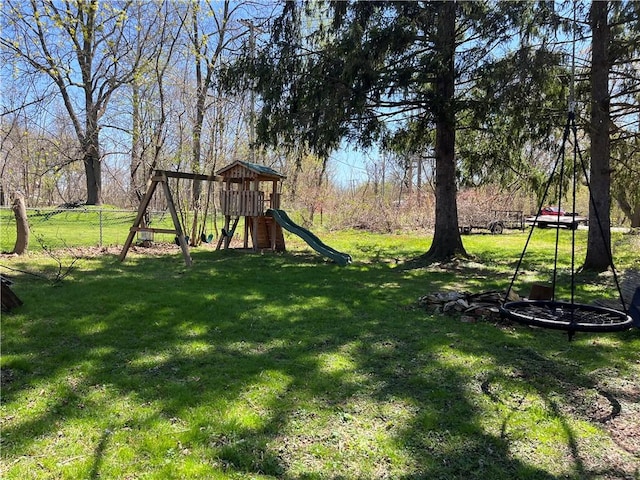exterior space with a playground and fence