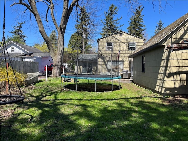 view of yard with fence and a trampoline