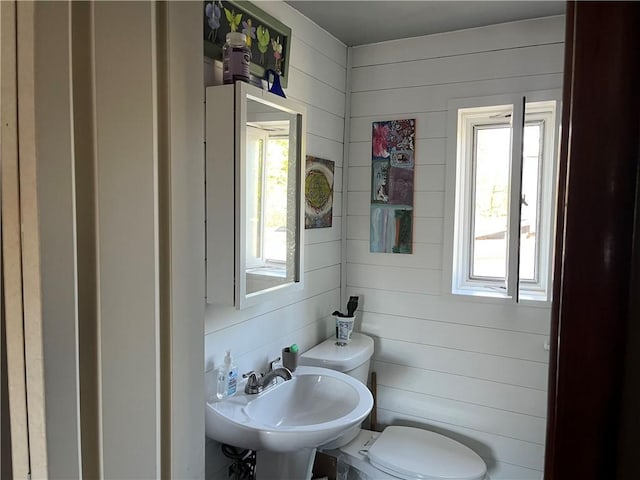 half bathroom with toilet and a sink