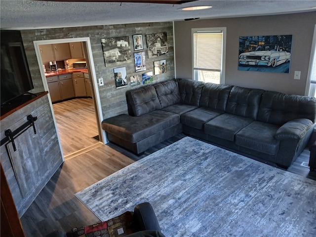 living area featuring a textured ceiling and light wood-style floors