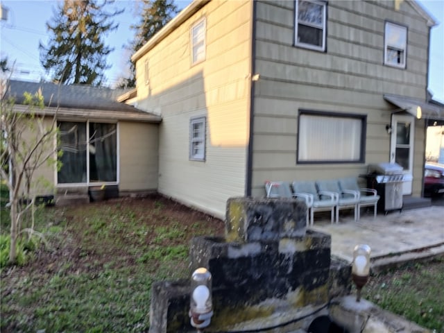 rear view of property featuring a patio