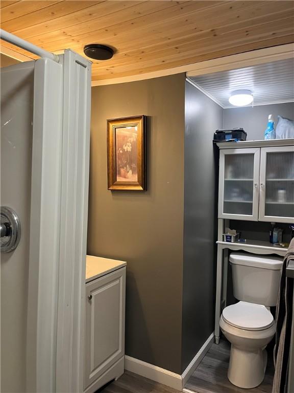 bathroom featuring wood ceiling, wood finished floors, toilet, and vanity
