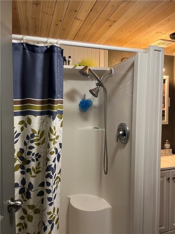 bathroom featuring wooden ceiling, a shower with curtain, and vanity