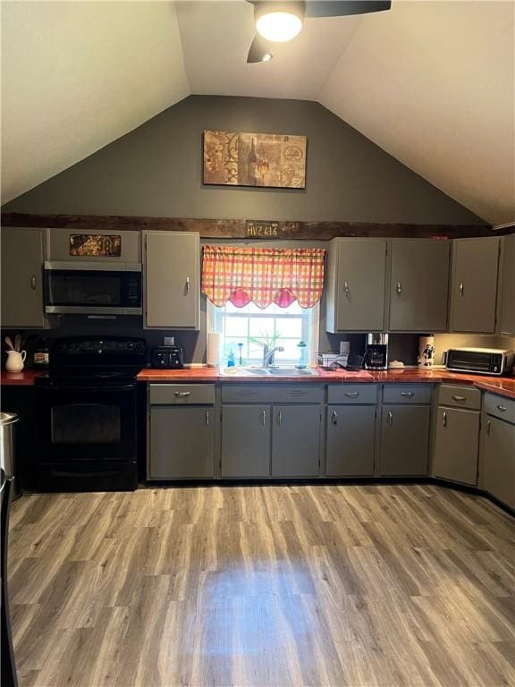 kitchen with ceiling fan, stainless steel microwave, gray cabinetry, and black electric range oven