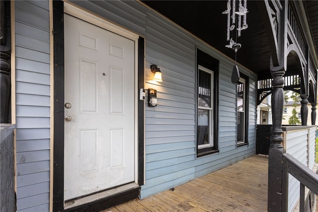 view of exterior entry with a porch