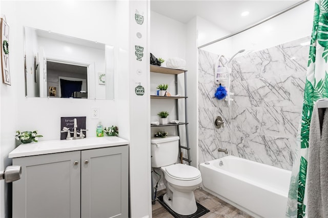 bathroom with shower / tub combo, wood finished floors, toilet, and vanity