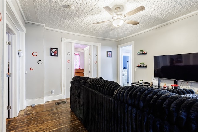 living room with visible vents, a ceiling fan, baseboards, and wood-type flooring
