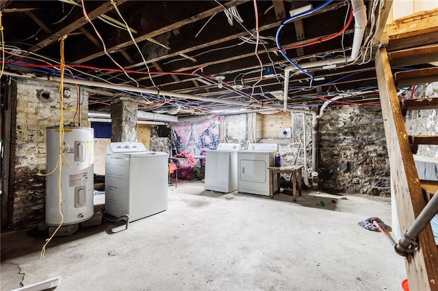 unfinished below grade area featuring water heater and washing machine and dryer