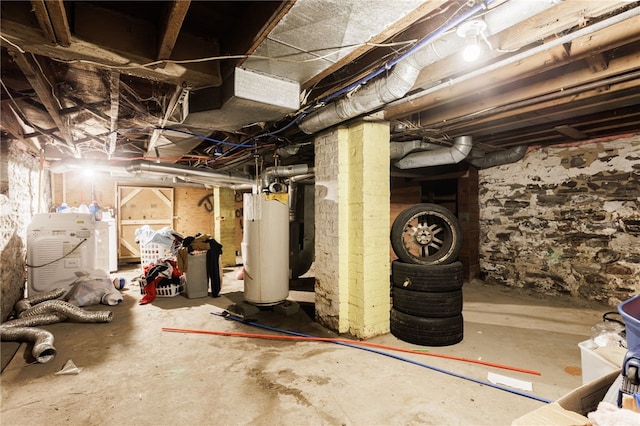 unfinished basement with gas water heater and washer / dryer