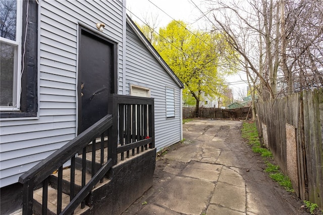 view of side of property with a patio and a fenced backyard