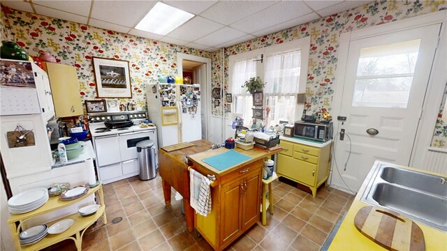 20 S Main St, Sherburne, NY 13460 - kitchen with light countertops, wallpapered walls, a drop ceiling, and white appliances