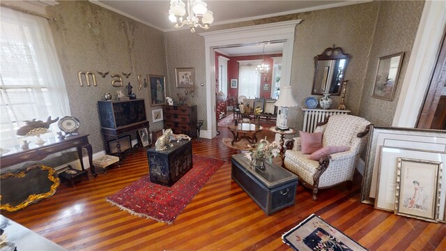 20 S Main St, Sherburne, NY 13460 - sitting room with ornamental molding, a notable chandelier, wallpapered walls, and wood finished floors