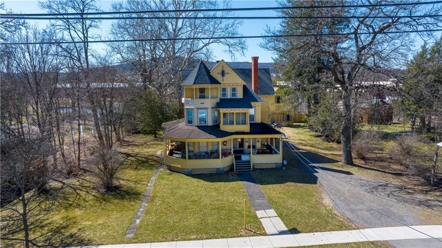 20 S Main St, Sherburne, NY 13460 - view of front facade with covered porch, a chimney, a front yard, and driveway