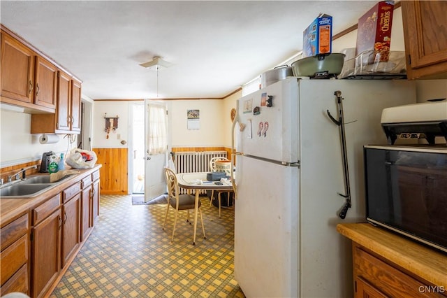 39 Ward St, Little Falls-City, NY 13365 - kitchen featuring brown cabinets, wainscoting, a sink, light countertops, and light floors