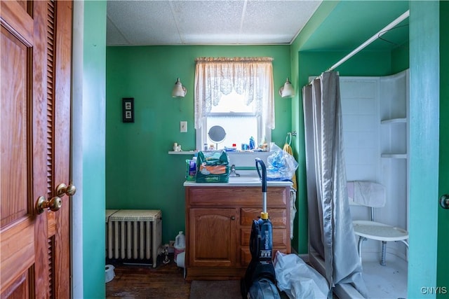 39 Ward St, Little Falls-City, NY 13365 - full bathroom with wood finished floors, a shower with curtain, radiator heating unit, and vanity