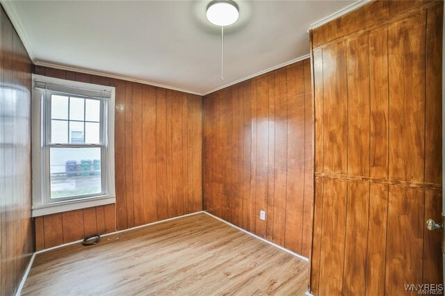 1001 Garden Ave, Niagara Falls, NY 14305 - unfurnished room featuring ornamental molding, wood walls, wood finished floors, and baseboards
