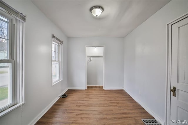1001 Garden Ave, Niagara Falls, NY 14305 - unfurnished bedroom featuring multiple windows, baseboards, wood finished floors, and visible vents