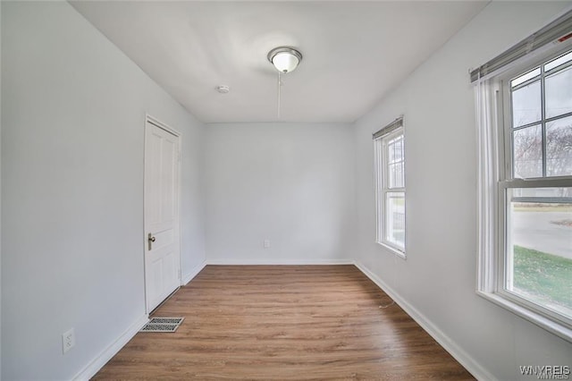 1001 Garden Ave, Niagara Falls, NY 14305 - spare room featuring baseboards, visible vents, wood finished floors, and plenty of natural light