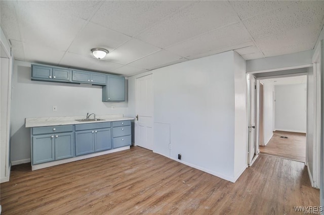 1001 Garden Ave, Niagara Falls, NY 14305 - kitchen featuring a drop ceiling, a sink, and blue cabinets