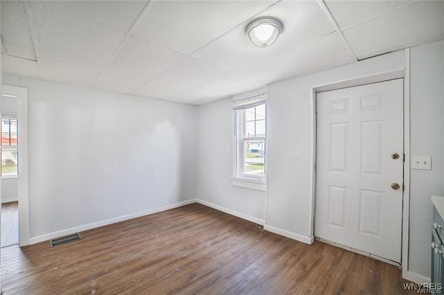 1001 Garden Ave, Niagara Falls, NY 14305 - spare room with dark wood-style floors, visible vents, a drop ceiling, and baseboards