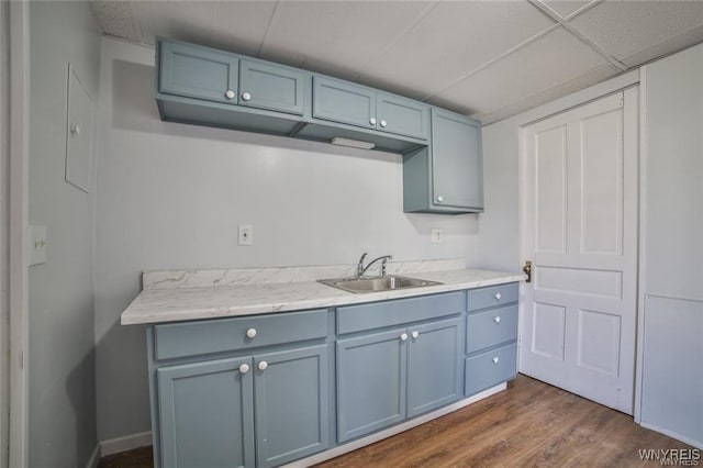 1001 Garden Ave, Niagara Falls, NY 14305 - kitchen featuring dark wood-type flooring, light countertops, blue cabinets, and a sink