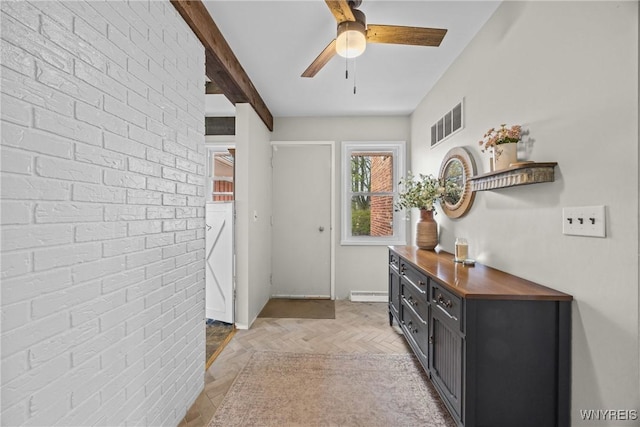 doorway to outside featuring visible vents, a ceiling fan, beamed ceiling, and baseboards