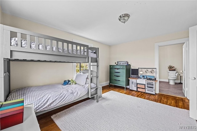 bedroom with wood finished floors and baseboards