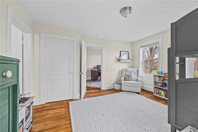 bedroom with wood finished floors and baseboards
