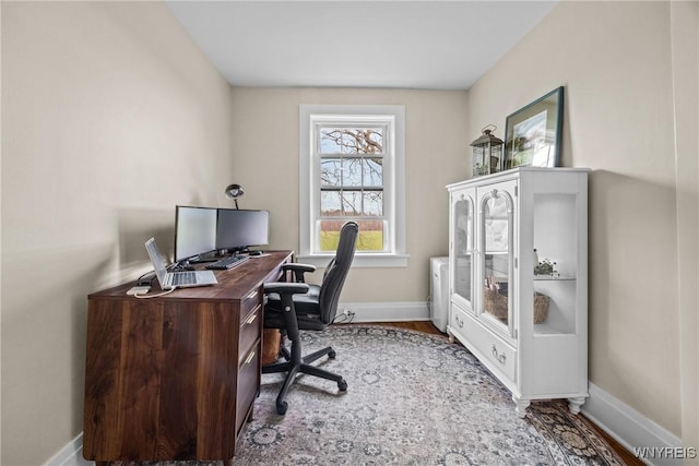office space with wood finished floors and baseboards